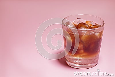 Iced coffee in a glass on pink background. Cold refreshment summer drink Stock Photo