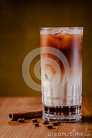 Iced coffee with ice. Frappe, frappuccino with cream and cinnamon on wooden table. copy space Stock Photo