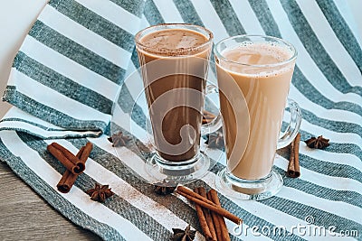 Iced coffee with milk in tall glasses, Cups of tasty frappe coffee, Latte machiato, two cups of cappuccino with cinnamon sticks Stock Photo