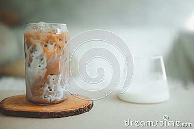 Iced coffee with fresh milk being poured into it showing the refreshing drink Stock Photo