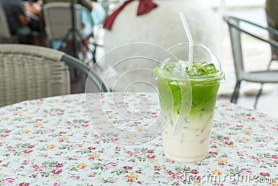 Iced Matcha green tea frappuccino in takeaway cup. Glass of green tea smoothies with fresh green tea. Stock Photo