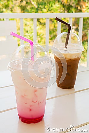 Iced pink milk and iced coffee in plastic cup Stock Photo