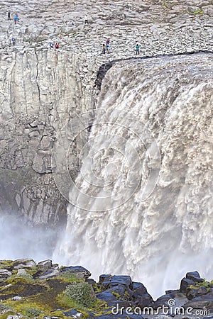 Tourists at Dettifoss. The waterfall is situated in VatnajÃ¶kull National Park in Northeast Iceland, and Editorial Stock Photo