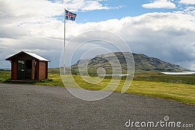 Iceland, 2008, June, Icelandic flag on a filed with a mountain in the background Editorial Stock Photo