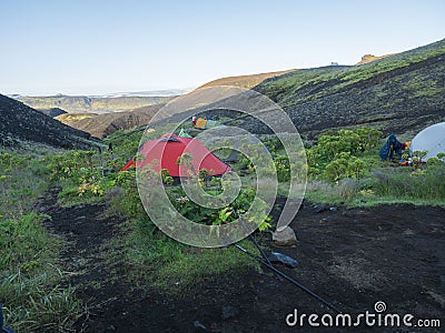 ICELAND, LANDMANNALAUGAR, August 2, 2019: Colorful tents in Botnar campsite at Iceland on Laugavegur hiking trail, green Stock Photo
