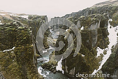 Iceland landscape photography. Picture of gorge FjaÃ°rÃ¡rgljÃºfur Fjadrargljufur. Moody clouds in the background and a river. Stock Photo