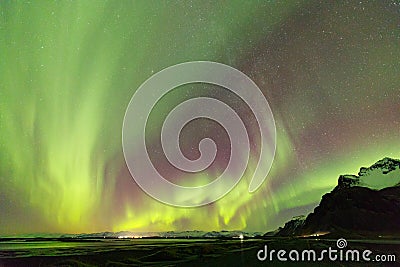 Iceland Northern Lights over Vestrahorn Mountain at Stokksnes peninsula in Southeast Iceland near Hofn Stock Photo