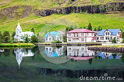 Icelandic landscape, view of Seydisfjordur with houses and reflecting in sea fjord lake water, Iceland Stock Photo