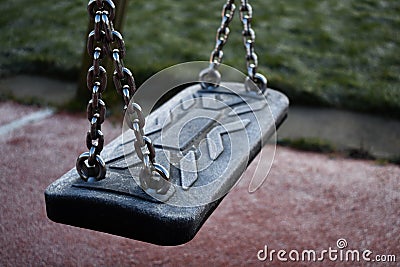 Icey Empty Swing In A Playground Stock Photo