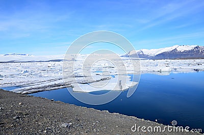 Icey Mountains Surrounding the Ice Melt in a Lagoon Stock Photo