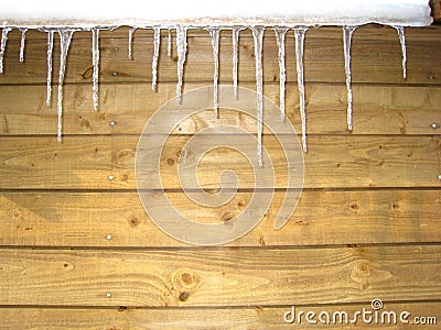 icicle in front of a wooden wall Stock Photo