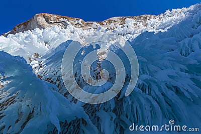 Icicle hanging from cliff above on Olkhon island in Baikal lake Stock Photo