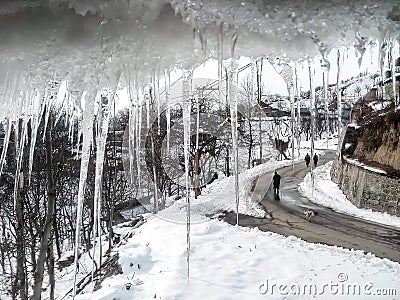 Icicle and snowy road Stock Photo