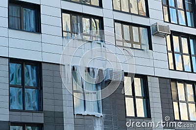icicle on the windows and glass of a modern house due to an accident in the heating system. Stock Photo