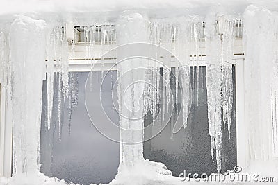 Icicle windows on winter time. Freeze temperatures backgrounds Stock Photo