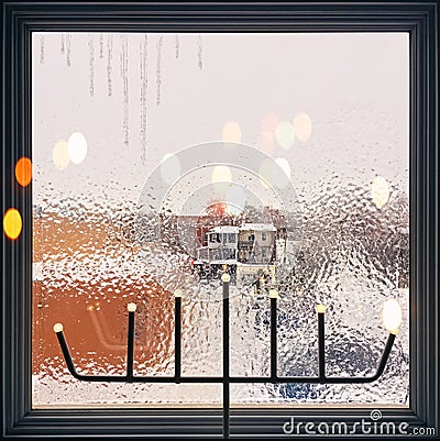 Icicles on a frosted window decorated with lights Stock Photo