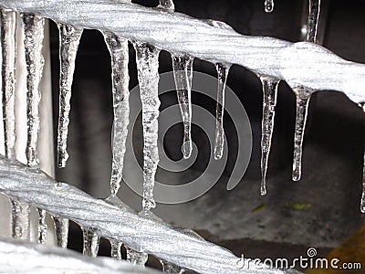 Icicles hanging from a metal wire Stock Photo