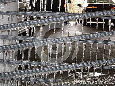 Icicles hanging from a metal wire Stock Photo