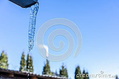 Icicles hanging from the roof Stock Photo