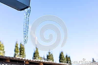 Icicles hanging from the roof Stock Photo
