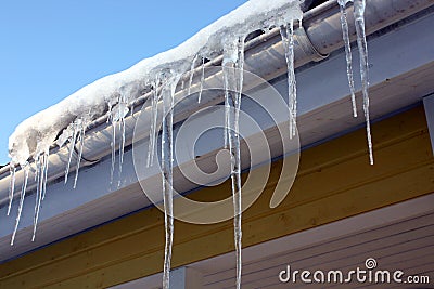 Icicles on house eaves Stock Photo