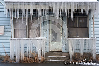 icicles surrounding a frosted window frame Stock Photo
