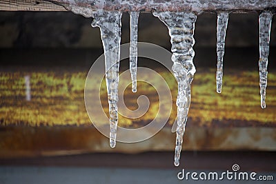 Icicles on vintage roof closeup. Winter weather concept. Froze and ice background. Snow and icicle. Melting icicles. Stock Photo