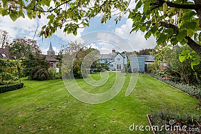 Blue traditional cottage and church Editorial Stock Photo