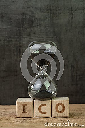 ICO, Initial Coin Offering for crypto currency to buy and sell on public concept, sandglass or hourglass on wooden cube block with Stock Photo