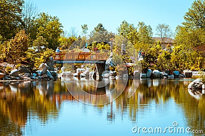 The iconic bridge at the Japanese gardens in the Frederick Meijer Gardens on a spring day in Grand Rapids Michigan Editorial Stock Photo