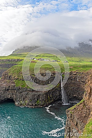 The iconic waterfall of Gasadalur on faroe islands and the remot Stock Photo