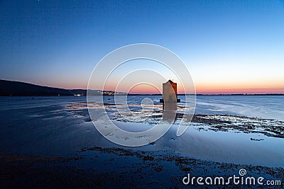 Iconic windmill in Orbetello at sunset, Tuscany Stock Photo