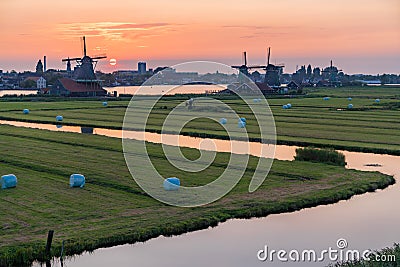 Iconic windmill sunset in Zaanse Schans Stock Photo