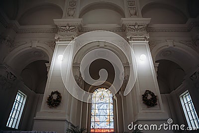 Icons, murals, angels and candles in the church. Interior of Peter and Paul cathedral in Peter and Paul Fortress, St. Petersburg Editorial Stock Photo