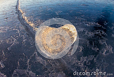 Icy heart in a crack in the light of sunset. lake Baikal Stock Photo