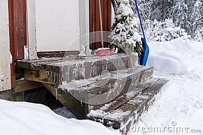 Icy stairs infront of a red wooden house in varmland sweden Stock Photo