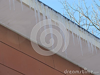 Icycles Hang from Apartment Building Stock Photo