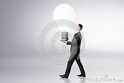 Idea concept with businessman carries big light bulb Stock Photo