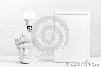 Idea concept with thinking head of antique statue David and abstract symbol of success thought as glow light bulb over head. Stock Photo