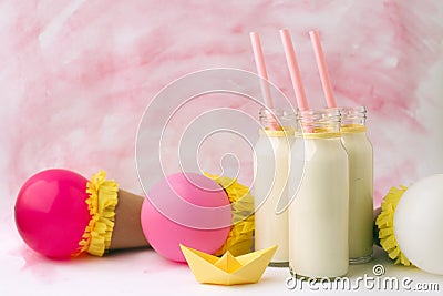 Idea decoration for baby shower party on table. Milk bottles and ballons, waiting for a baby girl Stock Photo