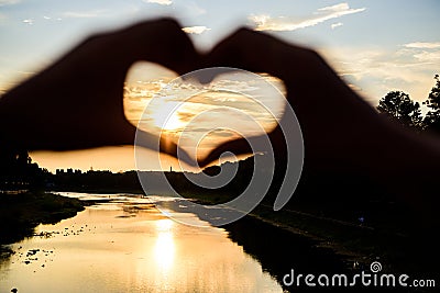 Idea honeymoon travel. Honeymoon summer resort. Romantic date ideas. Silhouette heart gesture symbol of love romance Stock Photo