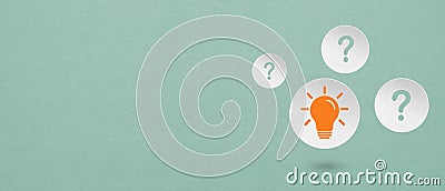 Idea, innovation, brainstorming concept. Bright orange light bulb on circle white paper cut with question mark and grunge Stock Photo