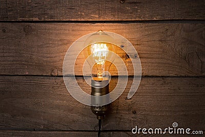 Idea and leadership business concept, vintage incandescent light bulb on the wooden background Stock Photo