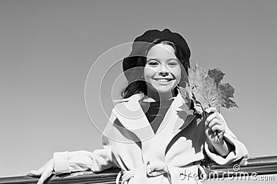 Ideas for autumn leisure. Little girl adore autumn season. Kid hold maple leaves. Small girl wear fall outfit outdoors Stock Photo