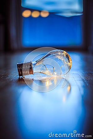 Ideas and innovation: Light bulb with LEDs is lying on the wooden floor. Window and light in the blurry background Stock Photo