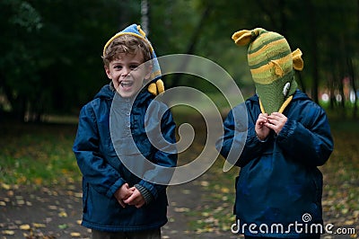 Identical twin brothers joking with the hat Stock Photo