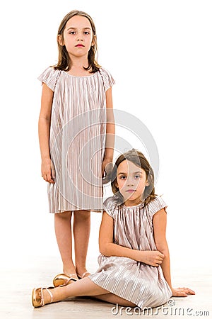 Identical twin girls sisters are posing for the camera Stock Photo