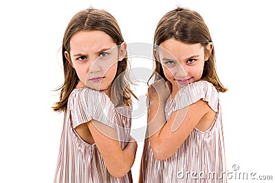 Identical twin girls sisters are posing for the camera Stock Photo