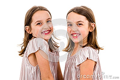 Identical twin girls sisters are posing for the camera Stock Photo