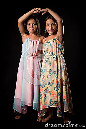 Identical twin girls sisters are posing for the camera Stock Photo